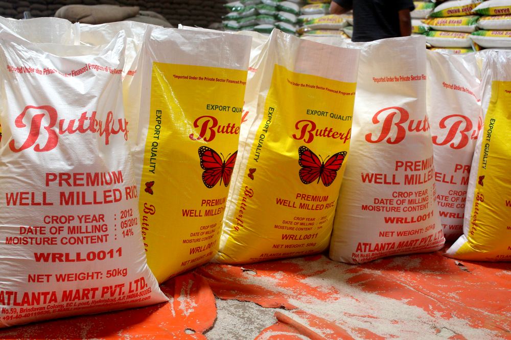 A row of filled, printed rice sacks standing on the mill floor