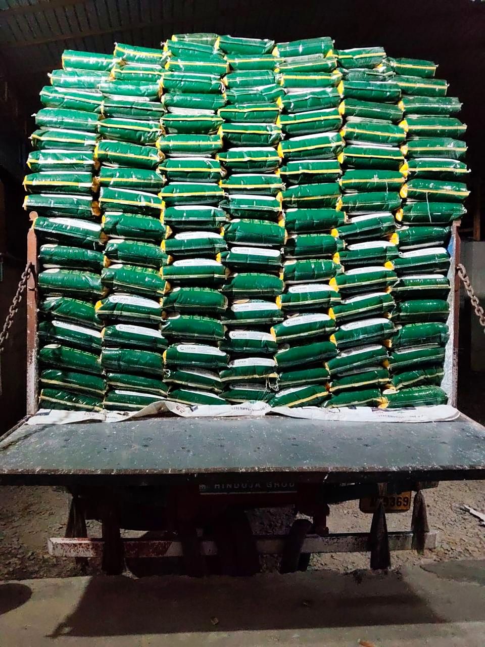 A truck stacked high with green Capiem rice sacks